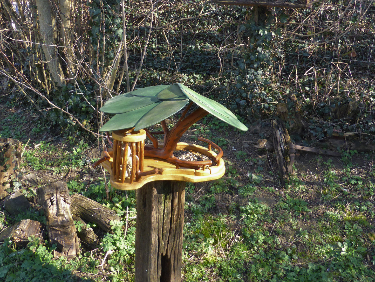 Vogelfutterhaus mit grünem Dach und Meisenknödelhalter